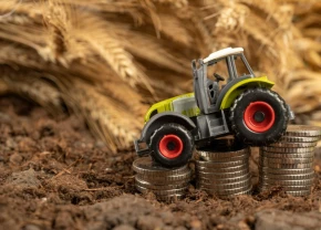Tracteur jouet descendant sur une pile d'argent